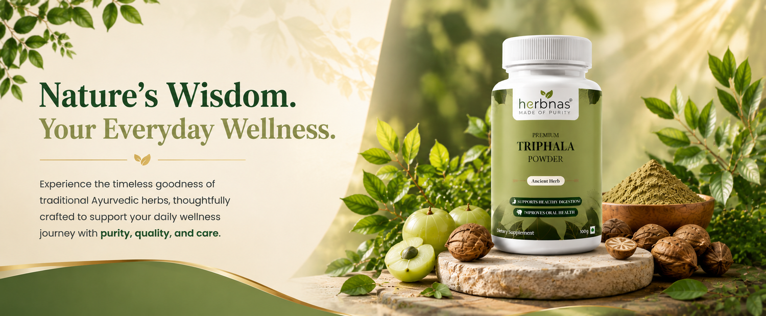 A bottle of herbnas Triphala Powder supplement displayed on a rustic stone slab with green leaves, apples, walnuts, and a small bowl of powder. The left side features a beige graphic panel with the text 'Nature's Wisdom.