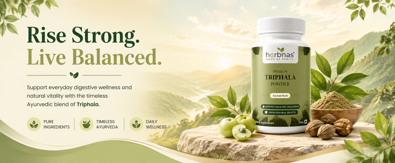 A bottle of herbnas Triphala Powder is displayed on a stone surface next to green leaves, a bowl of powder, and whole fruits, set against a scenic background of green hills and a warm rising sun. The left side features promotional text reading 'Rise Strong.